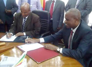 Signing an Agreement in a Formal Meeting with Officials