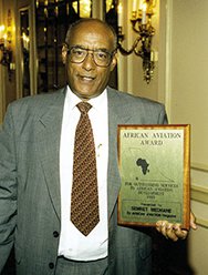 African Aviation Award Recipient Holding Plaque An individual proudly displays the African Aviation Award plaque.