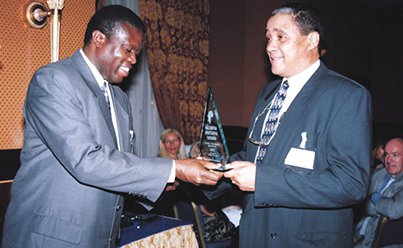 "Celebrating Achievement: Award Presentation Between Two Leaders"